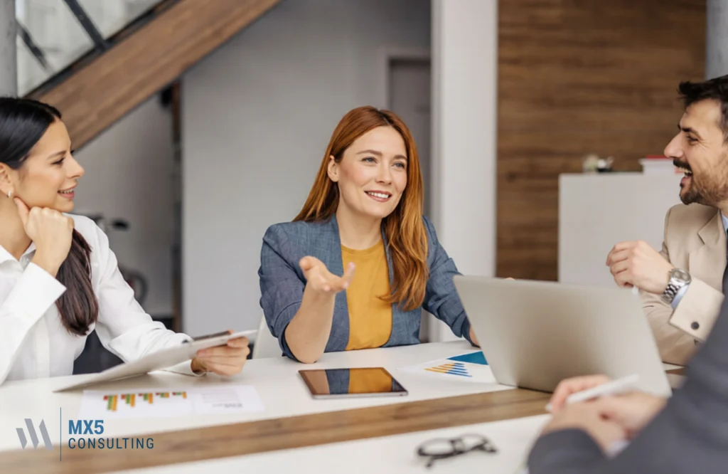 Business professionals analyzing charts and strategies to improve company performance through business consulting solutions